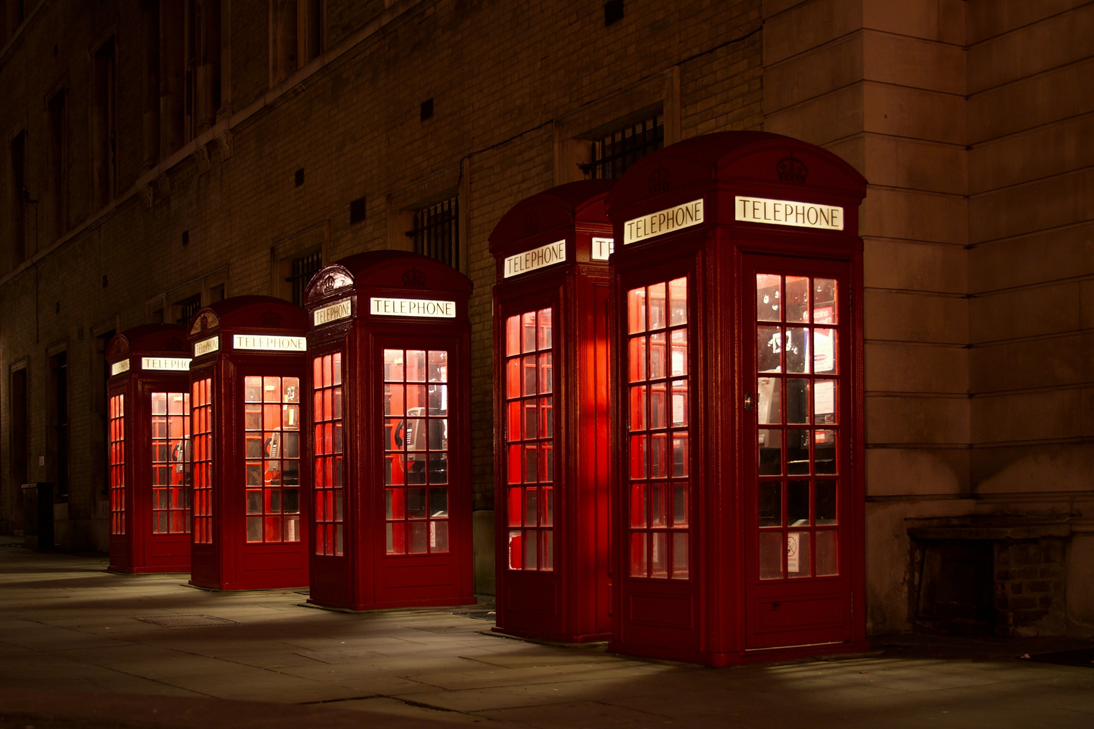 Four red British telephone booths